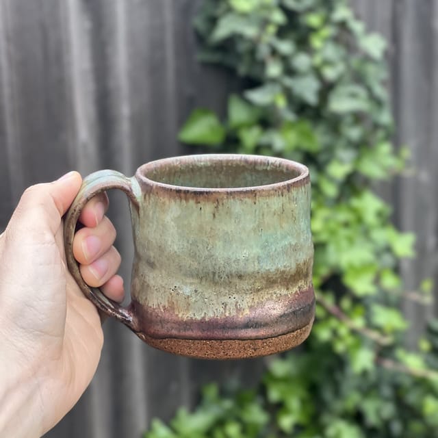 Mossy Creek Mug — Moss-green glaze running into a plum foot, like a creek bank after rain
